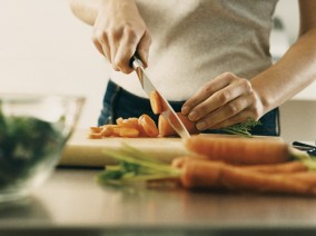 01-woman-chopping-vegetables-cutting-board-kitchen-lgn